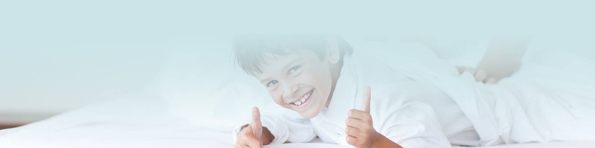 a boy making a thumbs up and smile