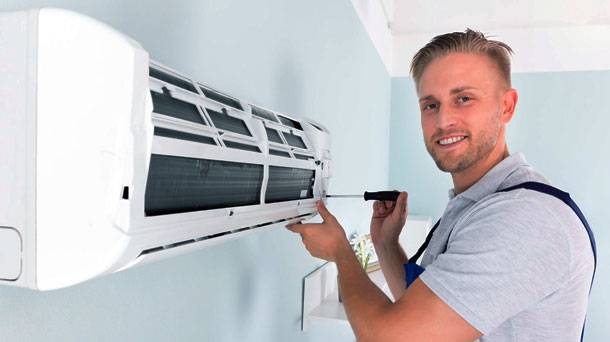 HVAC professional smile while working on ac installation at home